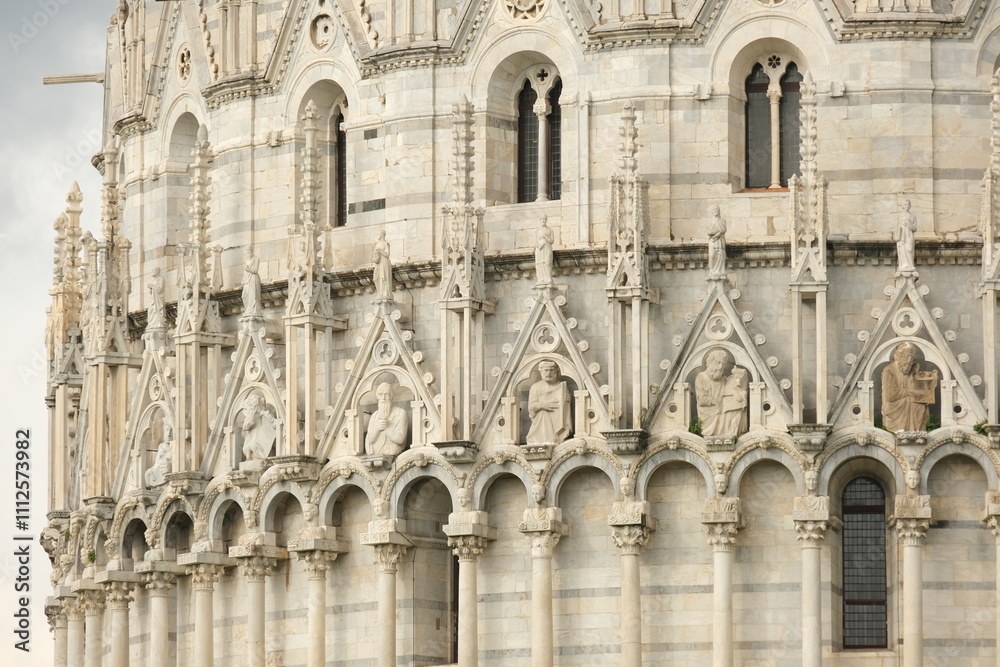 Romanesque architecture. Gothic marble decorations.Pisa Baptistery in Pisan Romanesque style, built in white Carrara marble with sculptures. Italy Romanesque architecture. Gothic marble decorations.Pisa Baptistery in Pisan Romanesque style, built in white Carrara marble with sculptures. Italy