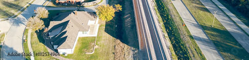 Panorama aerial view development of precast concrete walls noise barriers, sound mitigation light railroad Belt Line Road in Coppell, suburbs Dallas Texas, block wheel and engine noise by trains photo