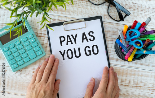 business woman holding a card with text PAY AS YOU GO photo