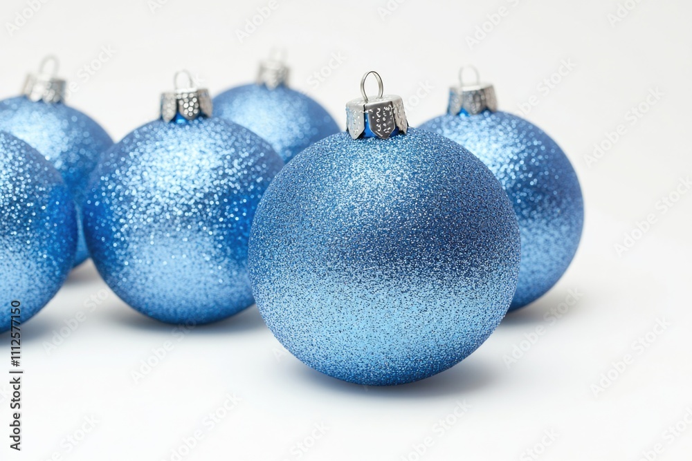 A collection of blue ornaments on a white surface, ideal for holiday and winter-themed designs A collection of blue ornaments on a white surface, ideal for holiday and winter-themed designs