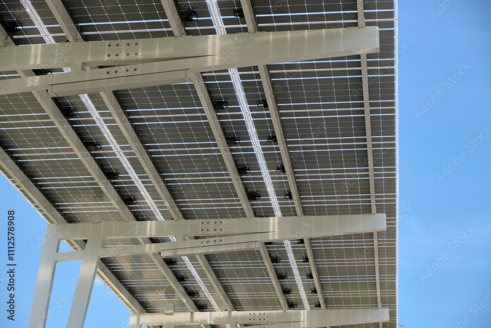 Solar panels installed over parking lot canopy shade for parked cars for effective generation of clean energy Solar panels installed over parking lot canopy shade for parked cars for effective generation of clean energy