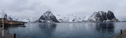 Canvas Print Snowy mountains reflecting in the calm waters of lofoten islands, norway