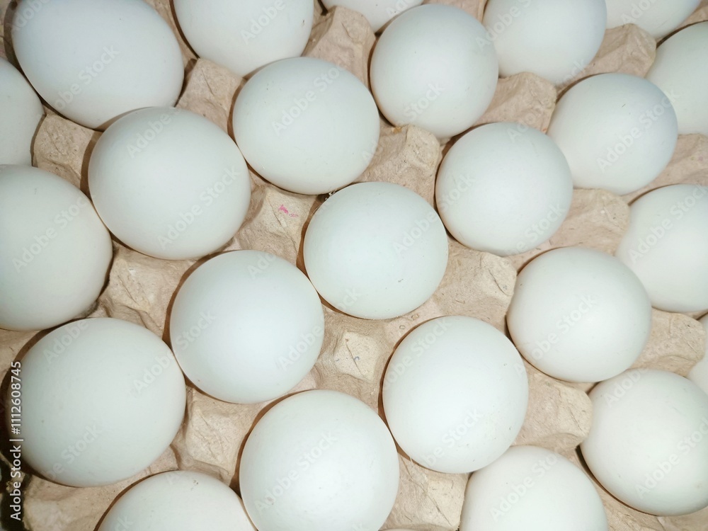 eggs in a basket raw chicken eggs in paper egg tray on white background. Group of Fresh white Eggs in a cardboard cassette. Organic food from nature good for health eggs in a basket raw chicken eggs in paper egg tray on white background. Group of Fresh white Eggs in a cardboard cassette. Organic food from nature good for health