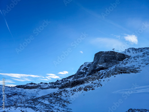 Overhead cable car on Hintertux Glacier in Tyrol, Austria Alps. Sunny day ski lift winter scenery.