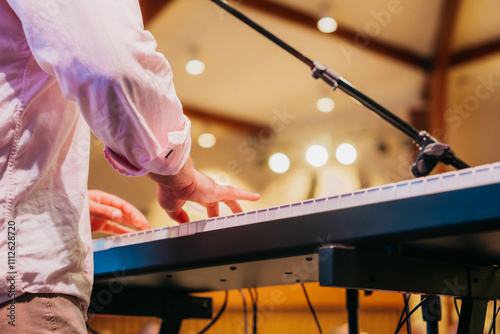 Worship leader playing piano, keyboard in church
