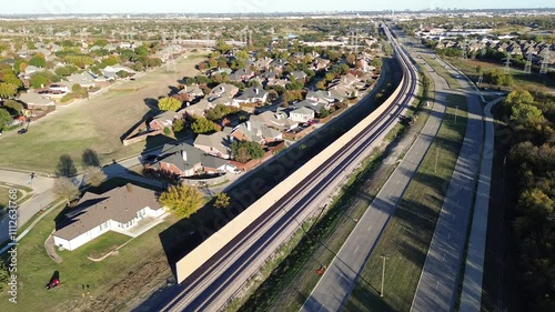 Continuing development of precast concrete walls noise barriers, sound mitigation light railroad Belt Line Road in Coppell, suburbs Dallas Fort Worth, block wheel engine noise by trains, flyover