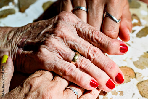 Affection and tenderness of a granddaughter to her grandmother. Traits of aging on the hands
