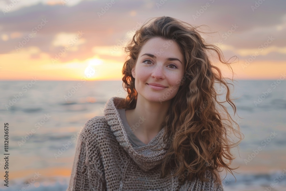 Portrait of a content woman in her 20s wearing a cozy sweater in beautiful beach sunset Portrait of a content woman in her 20s wearing a cozy sweater in beautiful beach sunset