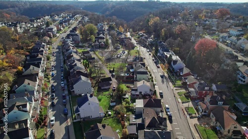 Drone and aerial landscape of midwestern residential neighborhood, homes, roads, sidewalks, and houses on top of Mount Washington next to downtown Pittsburgh, Pennsylvania on a cold, autumn day