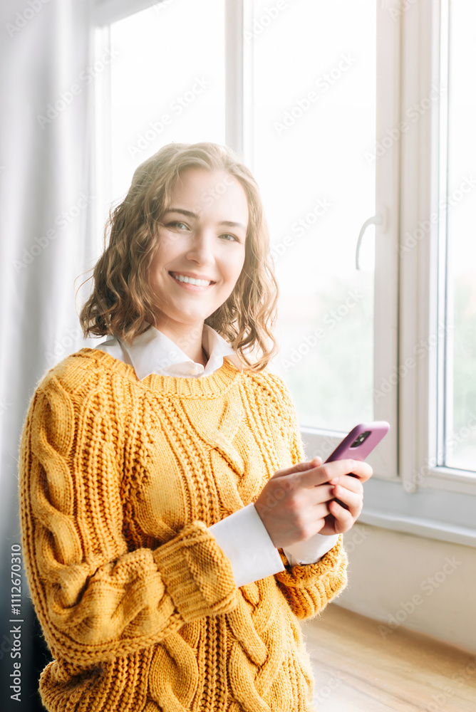 Joyful Woman Using Smartphone at Home. Smiling woman using her phone at home, enjoying online shopping and texting. Capturing a moment of happiness and modern lifestyle in a cozy indoor setting Joyful Woman Using Smartphone at Home. Smiling woman using her phone at home, enjoying online shopping and texting. Capturing a moment of happiness and modern lifestyle in a cozy indoor setting