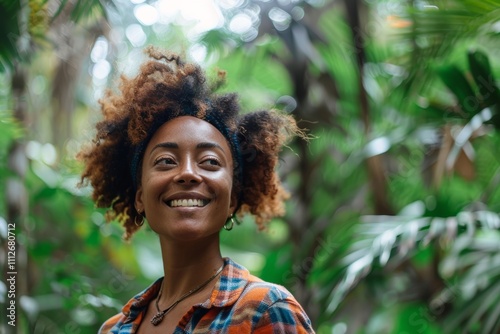 Portrait of a glad afro-american woman in her 30s dressed in a relaxed flannel shirt isolated in lush tropical rainforest photo