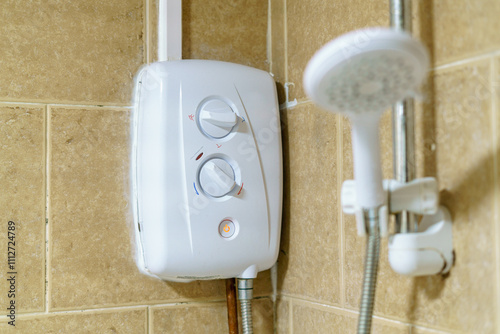 Tankless white water heater with shower head  photo