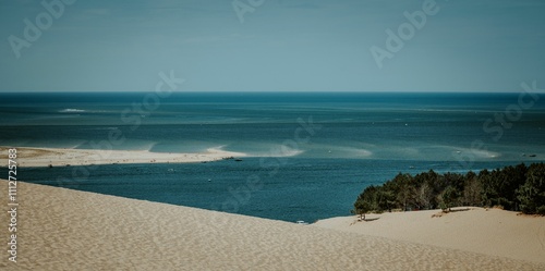 Fototapeta Naklejka Na Ścianę i Meble -  Scenic view of sandy dunes in a desert overlooking the sea in France