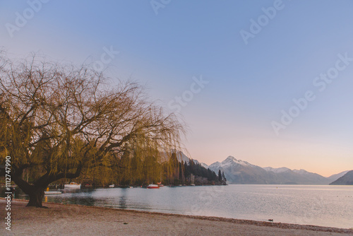 Lake Wakatipu in Queenstown, New Zealand, is surrounded by snow-capped mountains on a winter afternoon in June