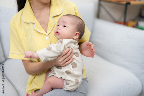 Mother helping baby to burp