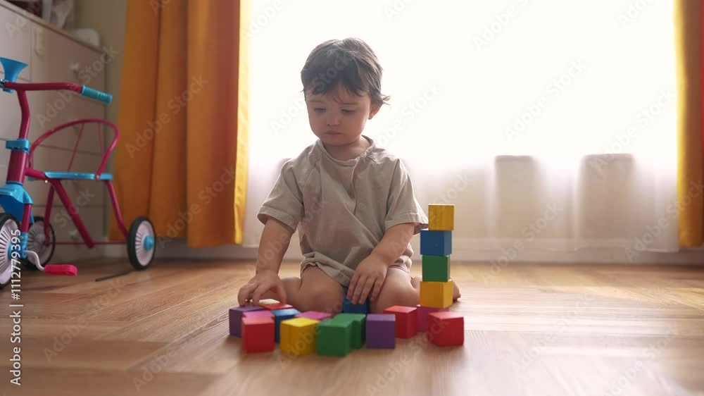 small child playing at home. happy and full of joy childhood, children's dream concept. beautiful little girl sitting on the floor and playing with lifestyle colorful cubes small child playing at home. happy and full of joy childhood, children's dream concept. beautiful little girl sitting on the floor and playing with lifestyle colorful cubes