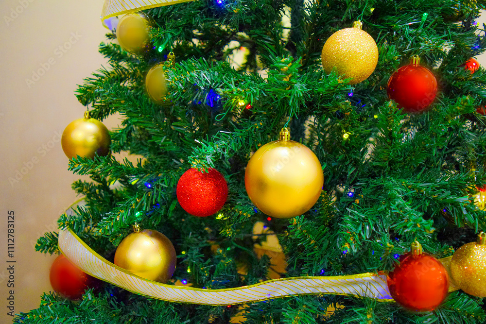 Macro close up view of dressed up christmas tree with bright vibrant colorful decorated baubles and glowing light bulbs ornaments. Winter festive holiday season. New year merry xmas holiday. Macro close up view of dressed up christmas tree with bright vibrant colorful decorated baubles and glowing light bulbs ornaments. Winter festive holiday season. New year merry xmas holiday.