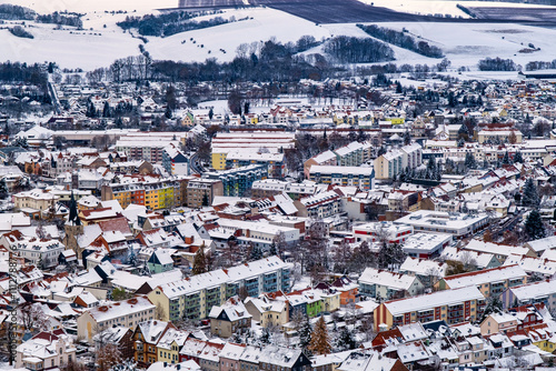 Obraz na płótnie A snowy landscape with a town in the distance. The sky is cloudy and the snow is covering the ground. Germany. w salonie
