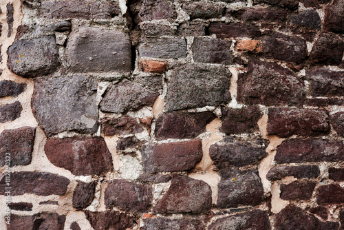 Obraz na płótnie A wall made of stone with a rough texture. The wall is brown and white w salonie