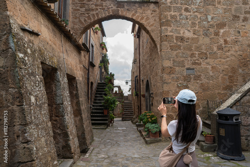 Exploring ancient charm: cobblestone street and archway photograph
