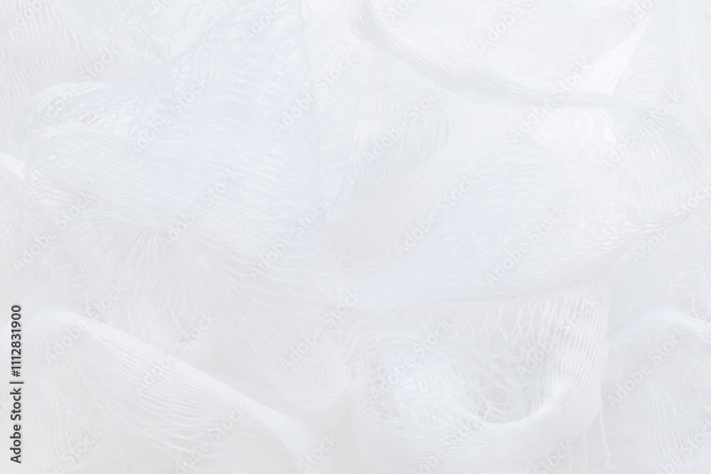 Obraz premium White new soft bath mesh sponge background. Closeup. Top down view.