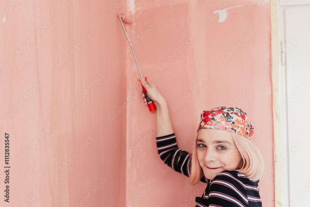 © Melika Tursic/Stocksy - Woman painting wall at home