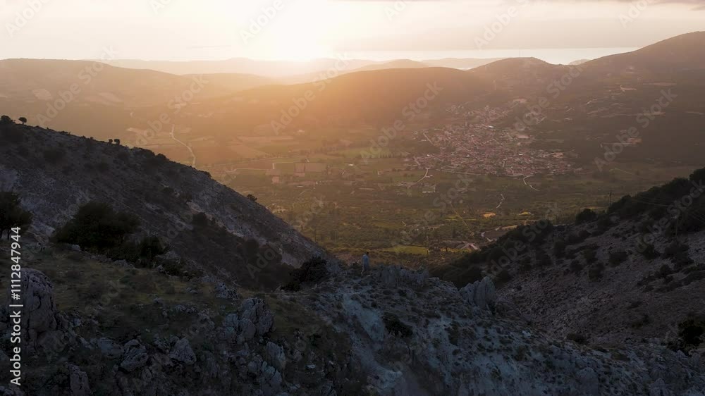 Warm sunlight illuminating picturesque valley from mountain peak Warm sunlight illuminating picturesque valley from mountain peak