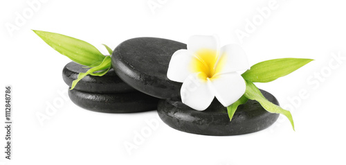 Spa stones, plumeria flower and green leaves isolated on white