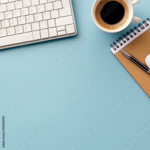 Workspace with keyboard, mouse, notebook, and coffee on a blue surface in mid...