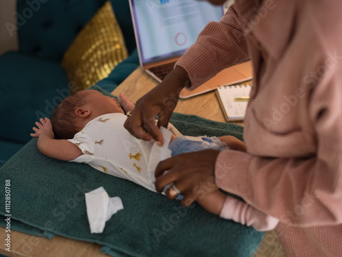 Anonymous mother changing diaper photo