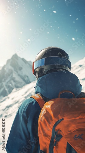 Snowy mountain adventure with a skier preparing for descent in bright sunshine