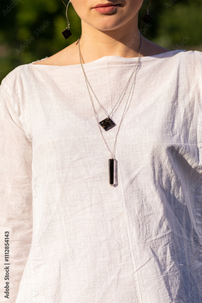 woman wearing two floral epoxy necklaces woman wearing two floral epoxy necklaces