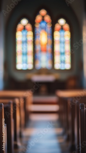 Serenity within a quiet church featuring stained glass windows and pews lined...