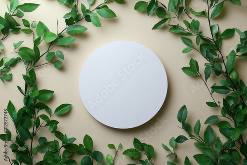 Round blank canvas surrounded by green leaves on a soft background
