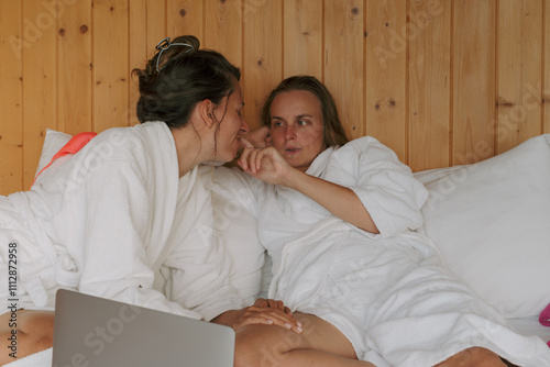 Couple sharing secrets while relaxing in a cozy cabin retreat photo