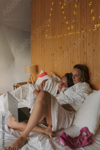 Cozy evening indoors with partners enjoying a movie together photo