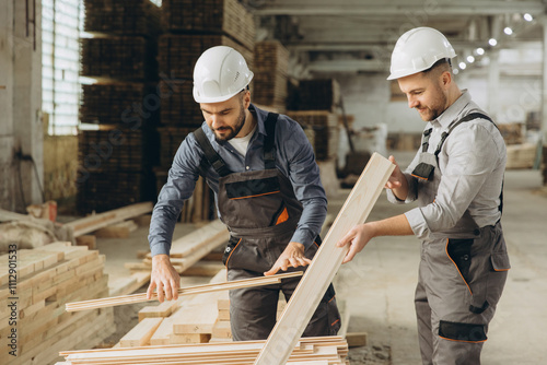 Εκτύπωση καμβά Carpenters working and examining wooden planks in workshop