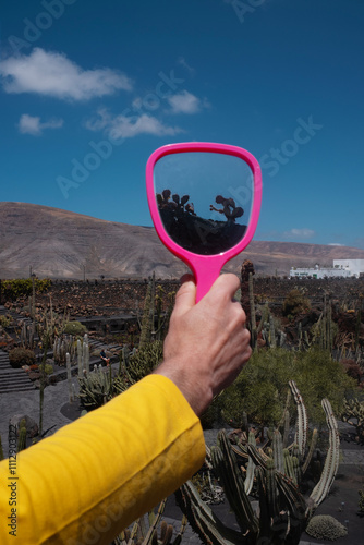 Hand Holding Mirror in Cactus Garden photo