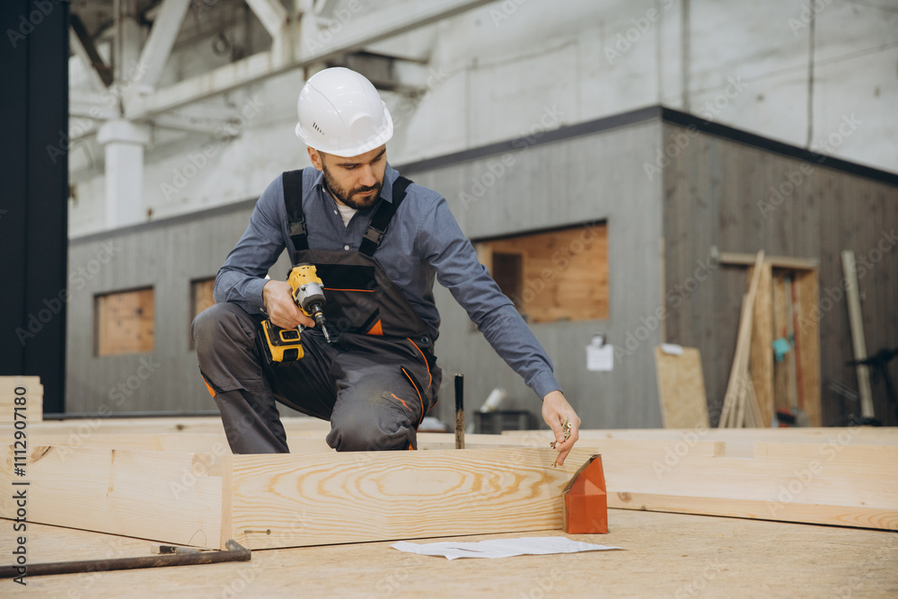 Carpenter building wooden frame for modular house in factory Carpenter building wooden frame for modular house in factory