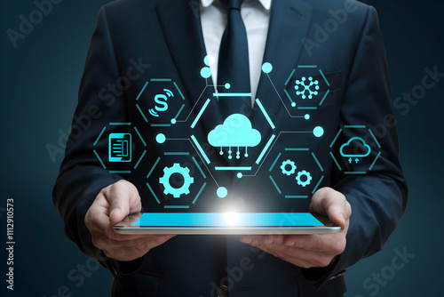 Suit clad man holds tablet with holographic icons, symbolizing advanced technology