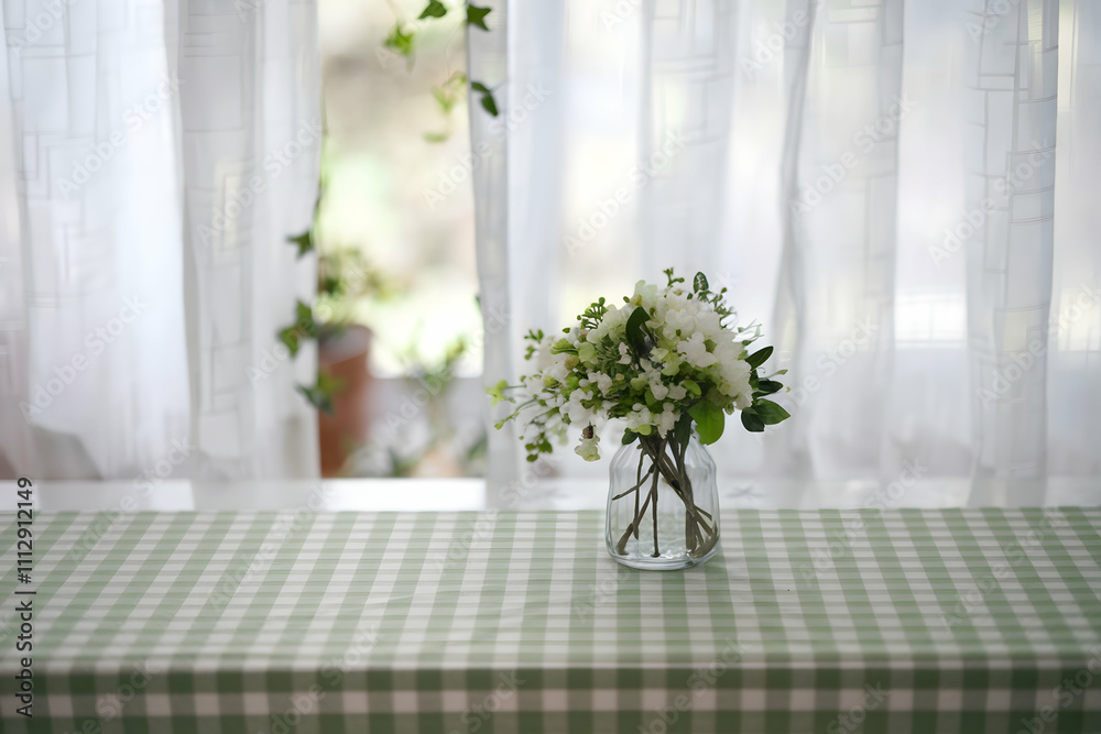 Fototapeta premium Green checkered tablecloth over white surface, sunlight filters softly through window