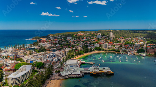 Aerial View of Manly Beach and Sydney harbour with manly houses on a warm summer day blue skies Sydney NSW Australia