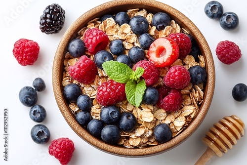 Oatmeal, decorated with fresh raspberries and blueberries, looks appetizing and delicious in a deep plate. The berries provide not only bright colors, but also natural freshness and vitamins. The oatm photo