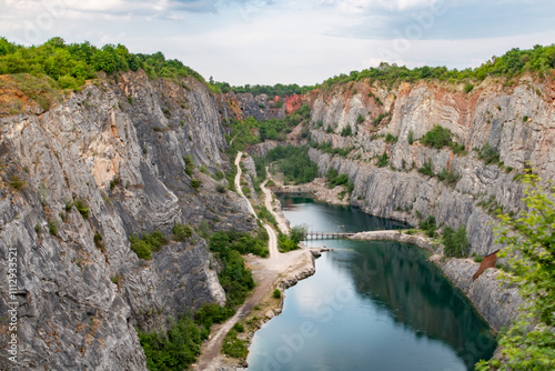 Quarry Little America with Rugged Cliffs, Scenic Pathway, and Reflective Water Body