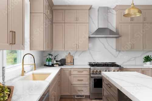 A kitchen detail with brown cabinets, marble countertop and backsplash, wood island, and gold faucet, sink, and light fixtures. No brands or labels.
