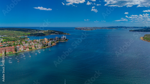 Aerial View of Manly Beach and Sydney harbour with manly houses on a warm summer day blue skies Sydney NSW Australia