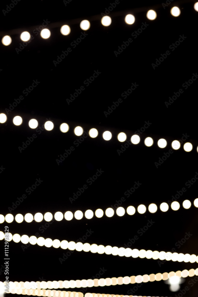 New Year's garlands of lamps on the street.Black background. Close-up New Year's garlands of lamps on the street.Black background. Close-up