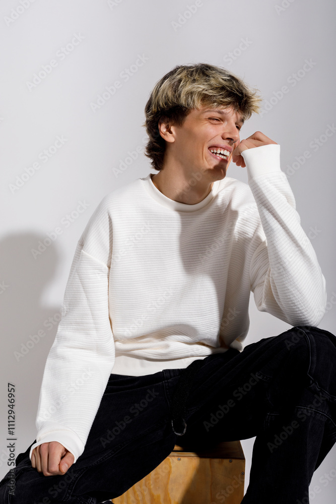 A young man enjoys a lighthearted moment A young man enjoys a lighthearted moment