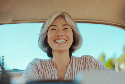 Free Download A mature asian woman is driving a car and smiling - GFXLoad