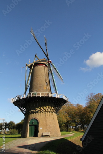 a beautiful historic corn mill and a blue sky photo